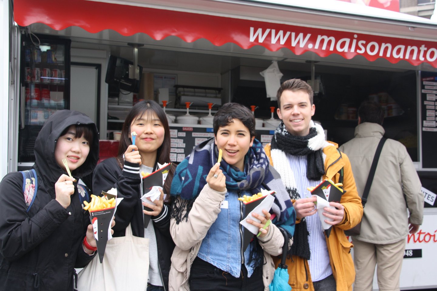 Four students with belgian fries in their hands