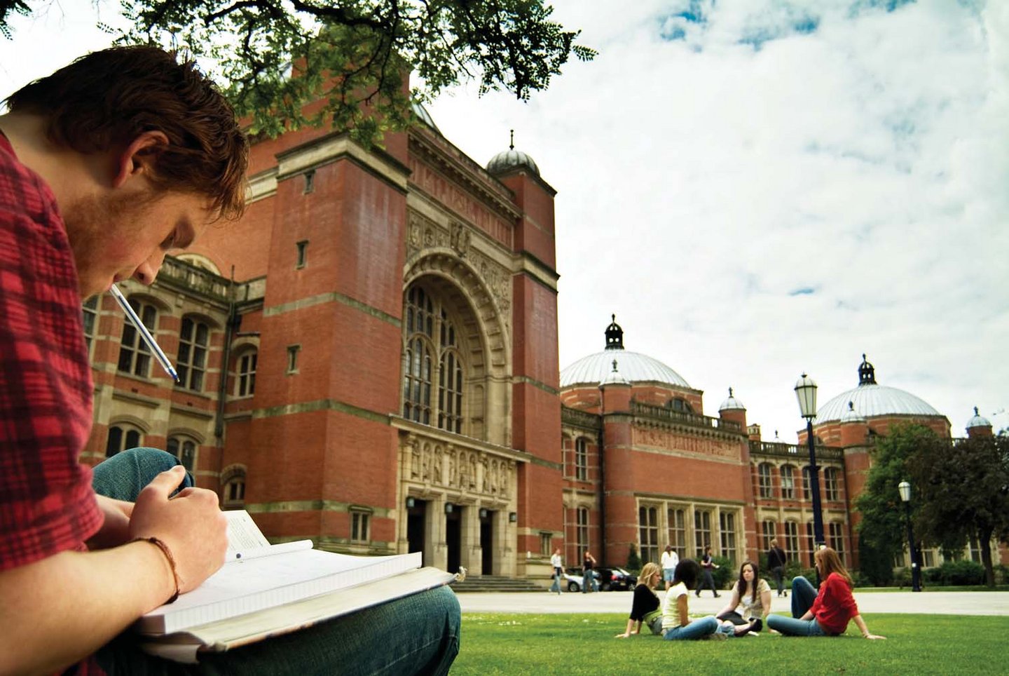 Student reading in front of University of Birmingham