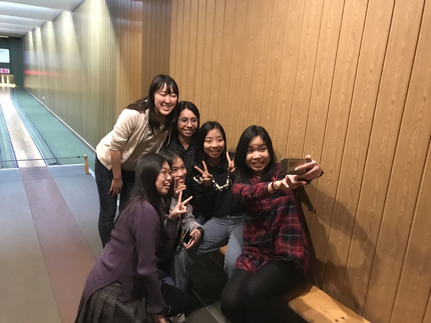 Six students taking a selfie at the bowling alley.