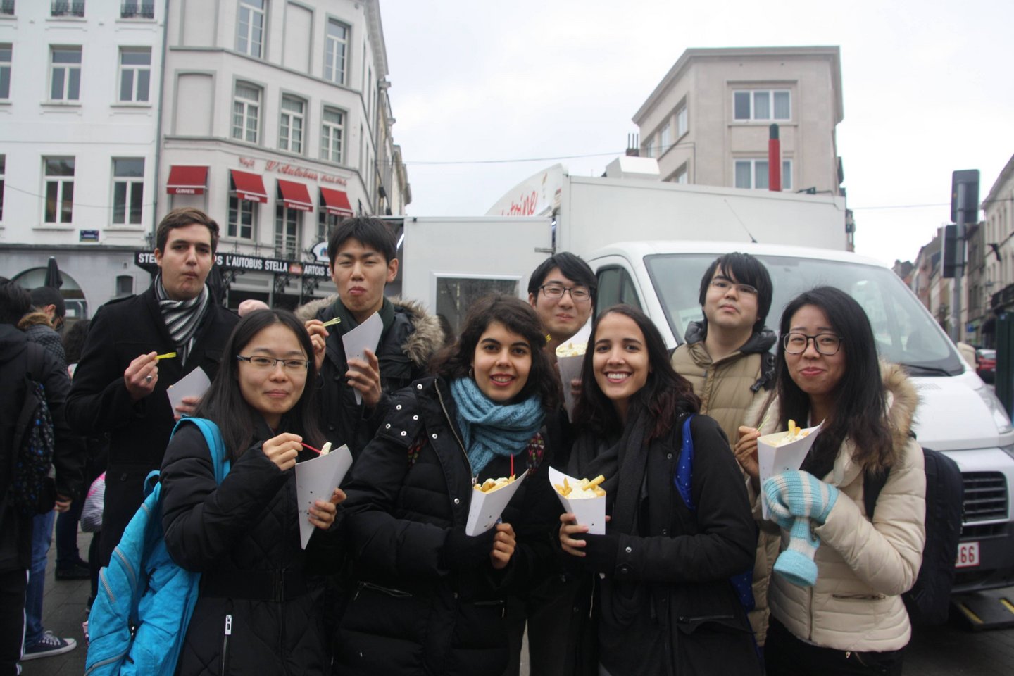 Students with bags of belgian fries in their hands