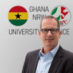 Photo of Georg Verweyen in front of the Ghana-NRW logo
