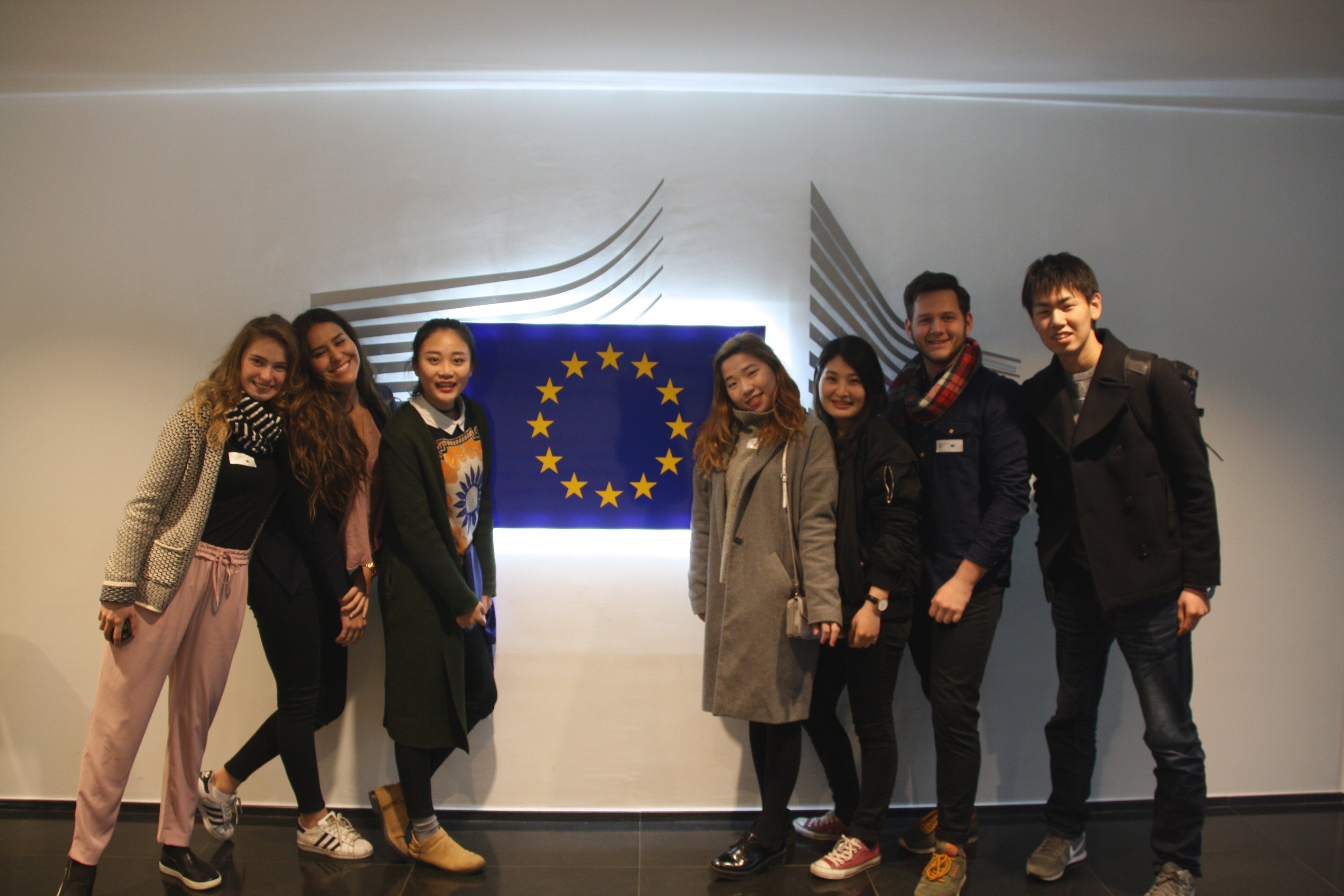 Students standing next to the logo of the European Commision 
