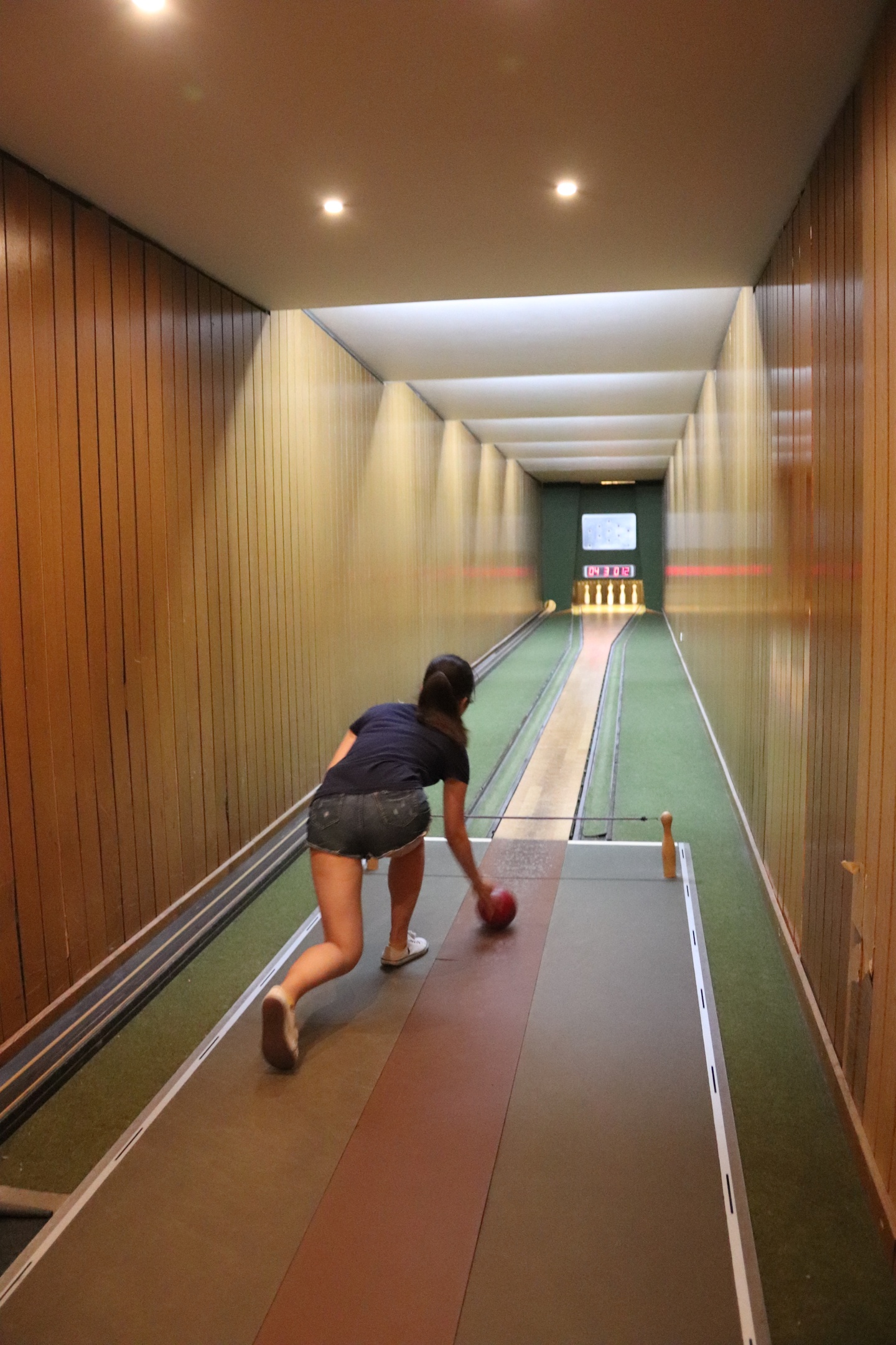 Backview of a student bowling