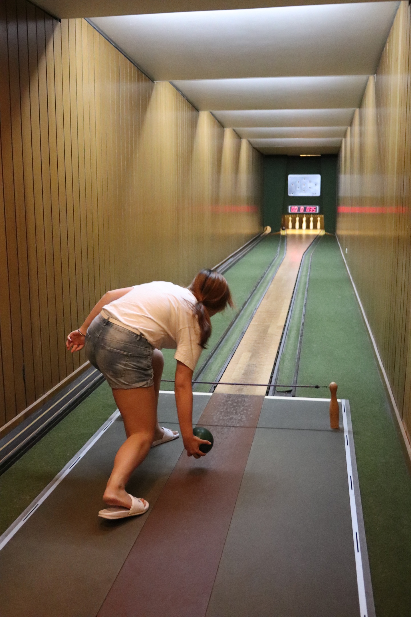 Back view of a student bowling