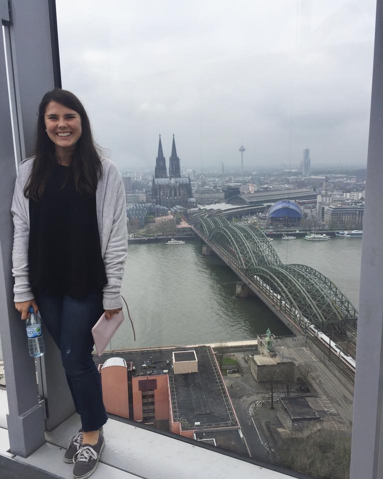 Female student on the triangle tower with view on the cologne cathedral and the hohenzollern bridge