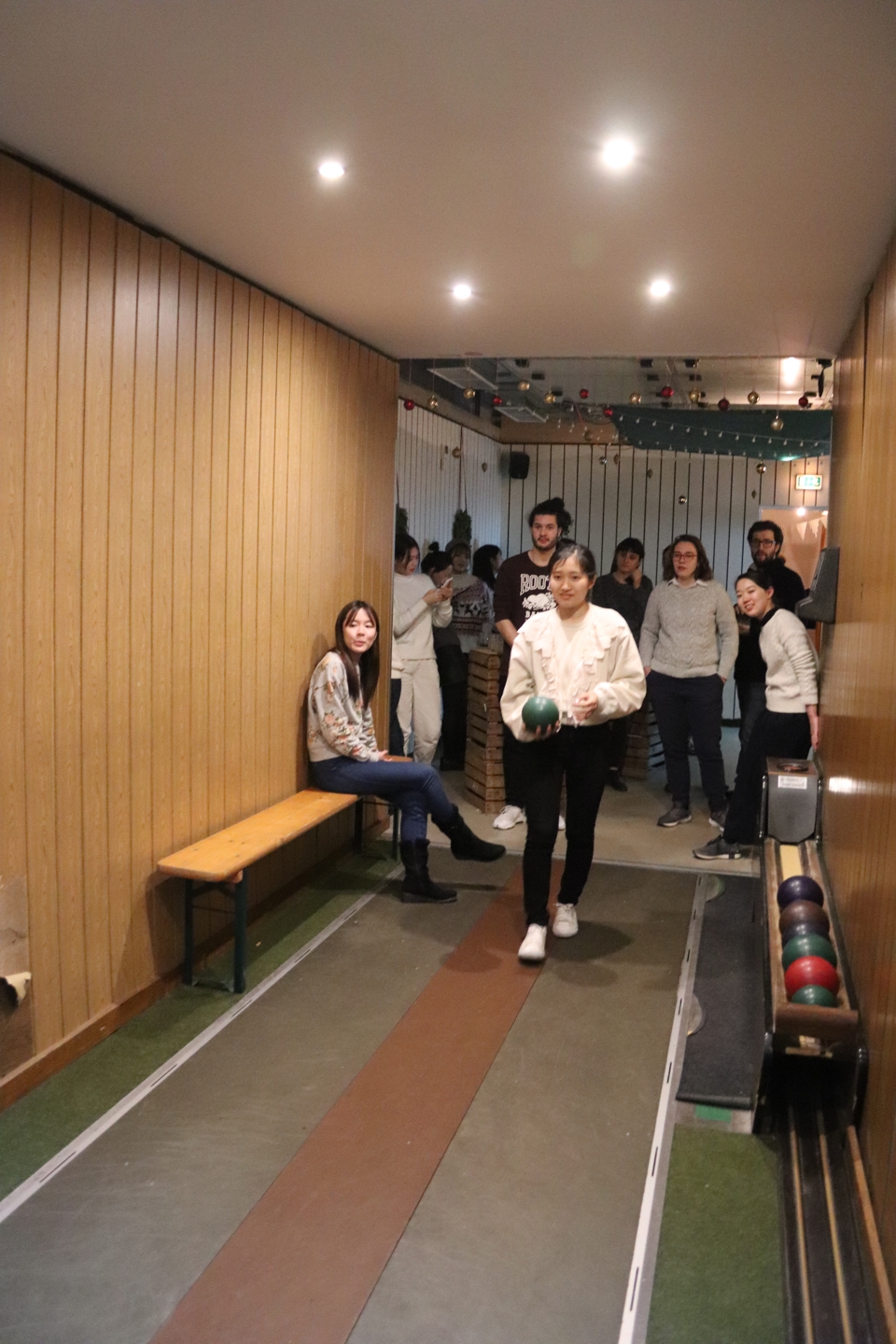 Front view of a female student bowling 